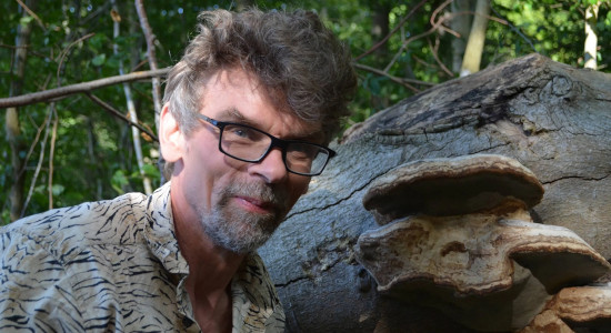 Close-up of group leader Jacob Heilmann-Clausen next to fungus.